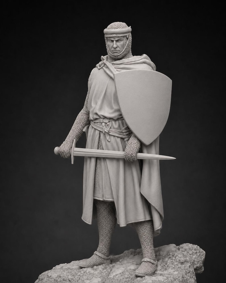 May include: A monochromatic gray figurine of a medieval knight standing on a rocky base. The knight wears a chainmail coif, a long tunic, and chainmail leggings. A cloak is draped over the shoulders, and the knight holds a sword and a shield.