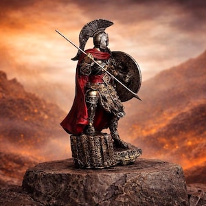 May include: A detailed figurine of a Spartan warrior, clad in ornate armor and a red cape, holding a spear and shield. The figure stands atop a stone base against a fiery, mountainous backdrop. The warrior wears a helmet with a tall crest.