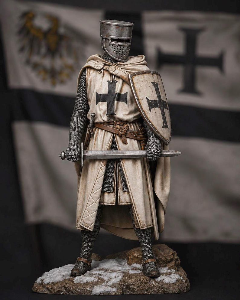 May include: A detailed figurine of a medieval knight wearing a flat-topped helmet, chainmail armor, and a cream-colored surcoat with a black cross. The knight holds a metal sword and a shield with a black cross, standing on a rocky, snow-dusted base.