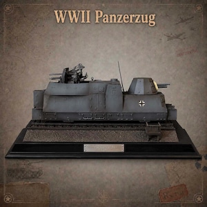 May include: A scale model of a dark grey WWII Panzerzug armoured train car featuring a mounted turret, a small cannon, and a German cross emblem. The model sits on a black display base with a metal plaque labelled Panzerzug BP-42 1942.
