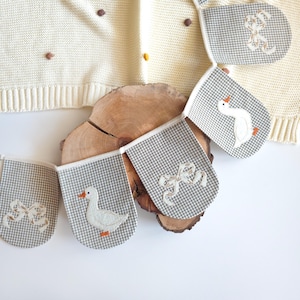 Kids room bunting with white geese on orange wavy ovals wearing blue hats, handmade cotton garland, nursery wall banner, goose nursery decor, baby room garland.