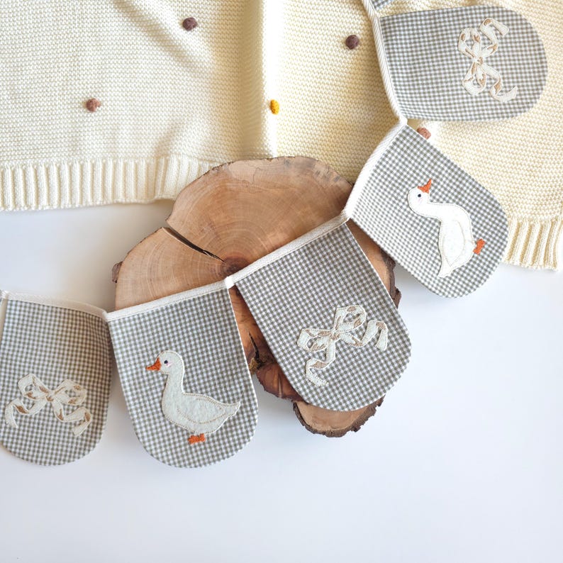 Kids room bunting with white geese on orange wavy ovals wearing blue hats, handmade cotton garland, nursery wall banner, goose nursery decor, baby room garland.