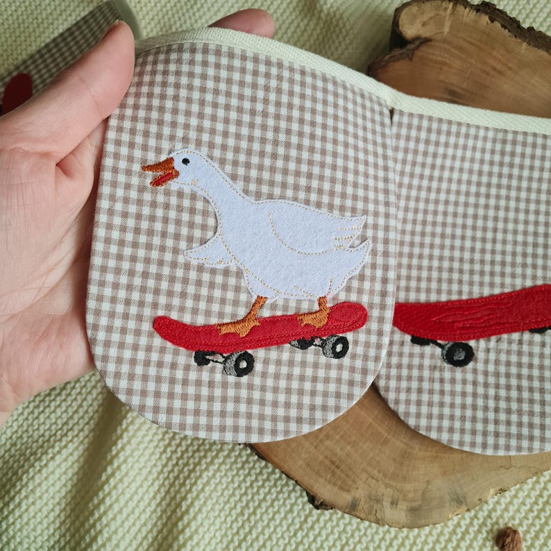 Light beige checkered kids room bunting with white geese on skateboards, whimsical goose garland and handmade garland for a modern nursery.