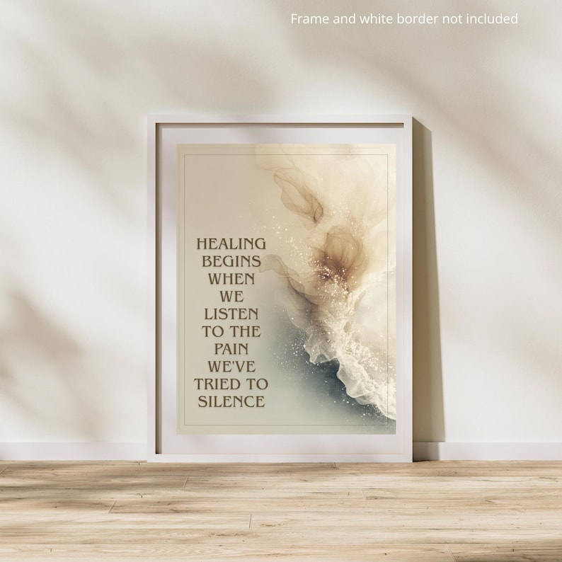 May include: A framed art print with the text "HEALING BEGINS WHEN WE LISTEN TO THE PAIN WE'VE TRIED TO SILENCE." The artwork features an abstract design with beige, brown, and blue hues. The print is in a white frame.