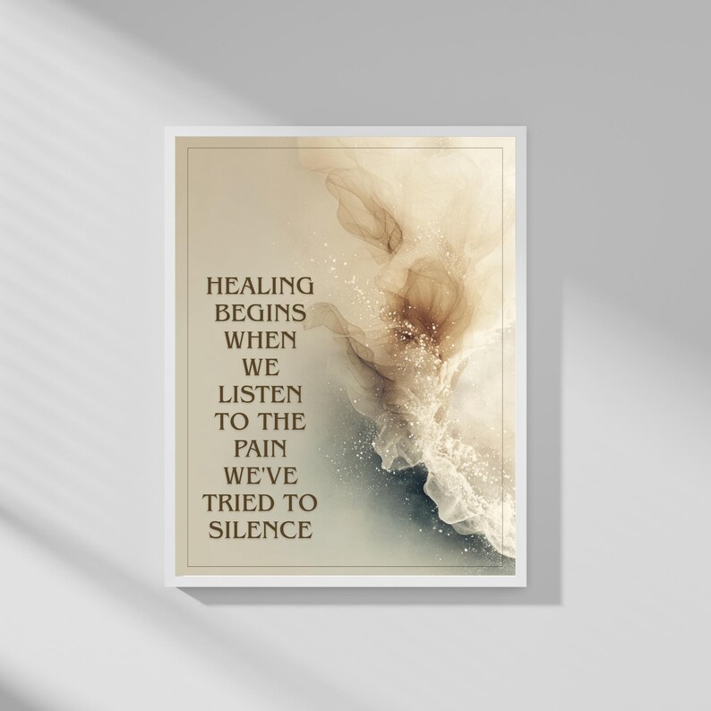 May include: A framed art print with the text "Healing begins when we listen to the pain we've tried to silence." The artwork features abstract watercolor-style designs in shades of beige, brown, and blue, with a white border.