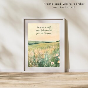 May include: A framed art print featuring a watercolor landscape of a field with wildflowers and rolling hills. The print includes the text "To grow, a child must feel accepted just as they are" in a handwritten font. The frame and white border are not included.
