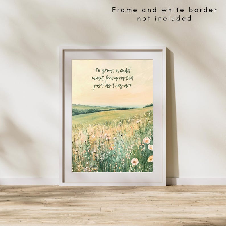 May include: A framed art print featuring a watercolor landscape of a field with wildflowers and rolling hills. The print includes the text "To grow, a child must feel accepted just as they are" in a handwritten font. The frame and white border are not included.
