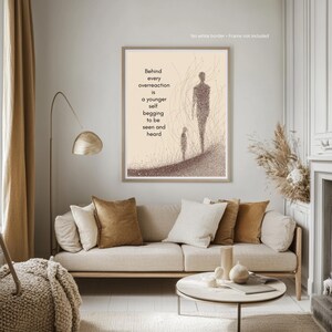 May include: A framed art print with a beige background and a minimalist illustration of two figures walking. The print includes the text: "Behind every overreaction is a younger self begging to be seen and heard."