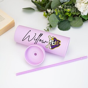 May include: A lilac tumbler with the name "Willow" in cursive. It has an ECU Pirates logo in purple and gold, plus a matching straw. The lid is removed, showing the inside of the tumbler.