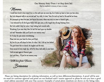 May include: A poem titled "One Memory Away" is printed on a woodgrain background. The poem is about remembering a loved one who has passed away. The poem is written in a handwritten font and is surrounded by a white border. A woman with red hair is sitting on a wooden bench in the background. She is wearing a red and black plaid shirt and a straw hat.