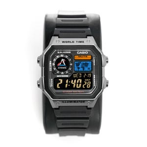 May include: A black Casio digital watch with a silver bezel. The watch face displays the time, date, and world map. The watch has the text "WORLD TIME", "CASIO", "ILLUMINATOR", and "10 YEAR BATTERY".