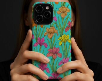 May include: A teal phone case featuring a repeating floral pattern of iris flowers in shades of orange, pink, and yellow, with green stems and leaves. The case is held up in front of a person.