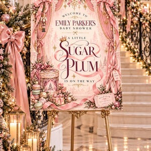 May include: A rectangular baby shower welcome sign featuring pink curtains, a nutcracker, ballet slippers, and macarons. The text reads: Welcome to Emily Parker's Baby Shower, A Little Sugar Plum Is On The Way, and Sugar Plum Grand Entrance.