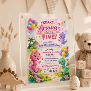 May include: A rectangular acrylic sign displaying a birthday invitation for Ariana turning five. The design features colorful cartoon dinosaurs, balloons, and tropical foliage. Text includes ROAR! Ariana is Turning FIVE! Join Us for a Dino-Mite Celebration! Saturday, September 12, 2026, 3:00 PM, 742 Willow Creek Drive, Austin, TX 78704, and RSVP by September 5, Call or Text (512) 555-3948.