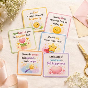 May include: A collection of square cards with inspirational messages and cute illustrations. The cards feature phrases like "Be kind," "Your smile," and "Sharing joy." The cards are surrounded by flowers, ribbons, and a pair of gold scissors.