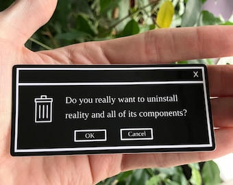 Op de afbeelding: Een zwart-witte sticker met de tekst "Do you really want to uninstall reality and all of its components?" in een pop-up venster ontwerp. De sticker bevat "OK" en "Cancel" knoppen en een prullenbak icoon.