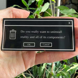 May include: A black rectangular sticker with a white border. The sticker features a trash can icon and the text "Do you really want to uninstall reality and all of its components?" with "OK" and "Cancel" buttons.