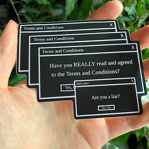 May include: Black and white stickers with a computer-style pop-up design. The stickers read "Terms and Conditions" and include the questions "Have you REALLY read and agreed to the Terms and Conditions?" and "Are you a liar?"