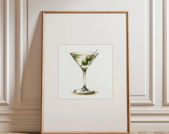 May include: A framed print featuring a watercolor illustration of a martini. The cocktail glass is filled with a clear liquid and garnished with two green olives on a toothpick. The artwork is set against a white background.