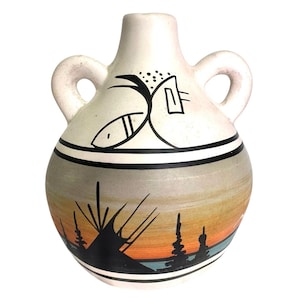 May include: A ceramic vase with two handles, painted with a sunset scene in orange, yellow, and blue. The vase features black and white geometric designs and a black band around the middle. The vase has a white background.