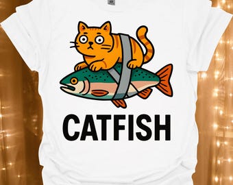 Catfish Illustration T-Shirt | Funny Cat Riding Fish Tee | Cat Lover's Tee | Fisherman Gift