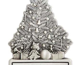 May include: Silver Christmas tree ornament with intricate detailing, including ornaments, a doll, and gifts. The base reads "Merry Christmas 2024 The Conner Family". A star tops the tree. A festive holiday decoration.