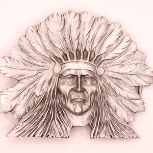 May include: A silver-toned metal belt buckle featuring a detailed relief sculpture of a person wearing a large, ornate feathered headdress. The design showcases intricate feather textures and facial features, with a polished metallic finish throughout.