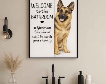 May include: Framed wall art featuring a German Shepherd dog. The artwork has the text "WELCOME to the BATHROOM" and "a German Shepherd will be with you shortly". The dog is brown and black, with a black frame.