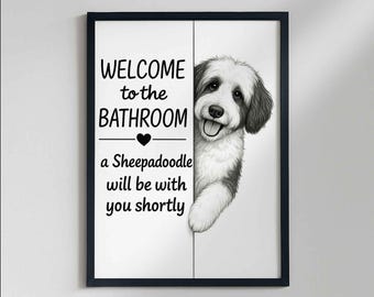 May include: Framed wall art featuring a black and white Sheepadoodle dog illustration. The text reads "WELCOME to the BATHROOM" and "a Sheepadoodle will be with you shortly". The dog's head and paw are visible, peeking from behind a white panel.
