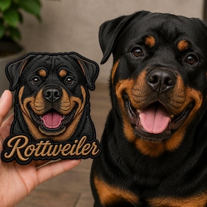 May include: A black and tan Rottweiler dog embroidered patch featuring a detailed portrait of a Rottweiler with its mouth open and tongue visible. The word Rottweiler is stitched in a cursive tan font at the bottom of the black-bordered patch.