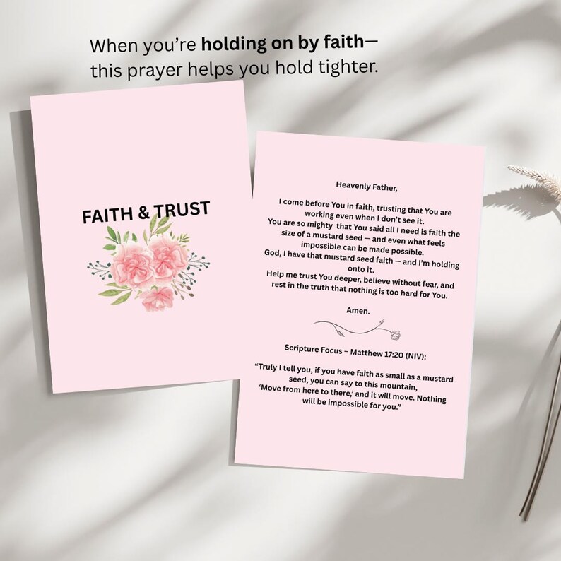 May include: Two pink cards with text and floral illustrations. One card reads "FAITH & TRUST" with pink flowers. The other card contains a prayer and a Bible verse from Matthew 17:20. The text on the cards reads "When you're holding on by faith - this prayer helps you hold tighter."