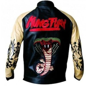 May include: Black jacket with tan sleeves and a black collar. The back features a red and green cobra design with the text "Kung Fury" in red. The sleeves have black tribal designs.