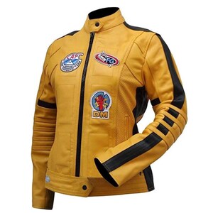 May include: Mustard yellow leather jacket with black accents and patches. The jacket features a stand-up collar, a full-length zipper, and black stripes on the sleeves. Patches include the text "CAT", "SFG", and "DM".