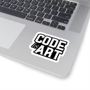 Pode incluir: Um autocolante branco com o texto "CODE is ART" em negrito preto. O autocolante está colocado num laptop prateado, com o teclado visível. O design do autocolante é simples e moderno.