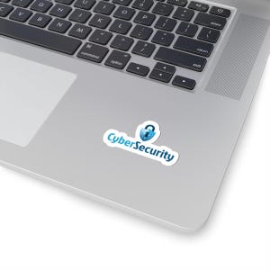 May include: A white sticker with the words "CyberSecurity" in a blue font, and a blue padlock icon. The sticker is on a silver laptop.