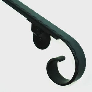 May include: A black, wrought iron handrail with a textured surface. The handrail curves into a decorative scroll design. The handrail is mounted on a round, black support.