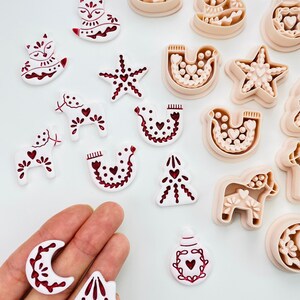 Scandinavian folk art Christmas clay cutters with dala horse, fox, and dove.