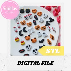 May include: A collection of Halloween-themed cookie cutters in various shapes, including ghosts, pumpkins, bats, and skulls. The cutters are arranged on a white plate, with the text "Sibillas cutters" and "DIGITAL FILE" visible.