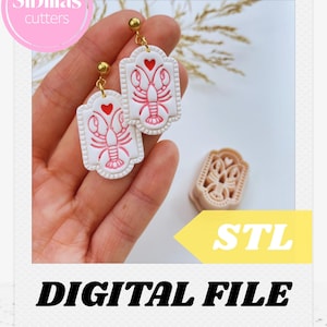 Könnte beinhalten: Weiße und rote Hummer-Ohrringe mit goldfarbenen Akzenten. Die Ohrringe zeigen ein Hummer-Design mit einem Herz darüber. Das Bild enthält auch einen passenden Ausstecher und den Text "DIGITAL FILE".