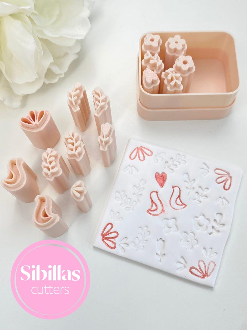 A close-up image of a Nordic floral stamp for polymer clay, showcasing the engraved design inspired by Scandinavian folk art. The deep relief allows for crisp impressions in clay, perfect for use in DIY jewelry, crafts, and handmade accessories. The material is durable and lightweight, and the carving shows heart and flower shapes common in traditional folk motifs. This stamp is ideal for makers who love boho, vintage, and Nordic aesthetic details in their creations.