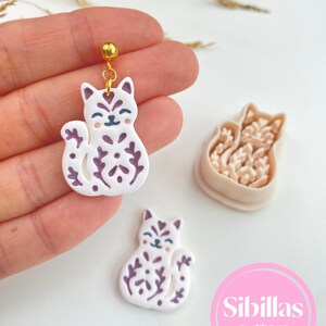 Polymer clay cutters for earrings with Nordic fall designs, folk art details, Halloween shapes, and handmade jewelry tools.