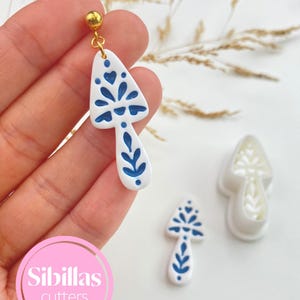 Polymer clay earring cutters with Scandinavian folk art shapes, perfect for fall jewelry, Halloween charms, and clay crafts.