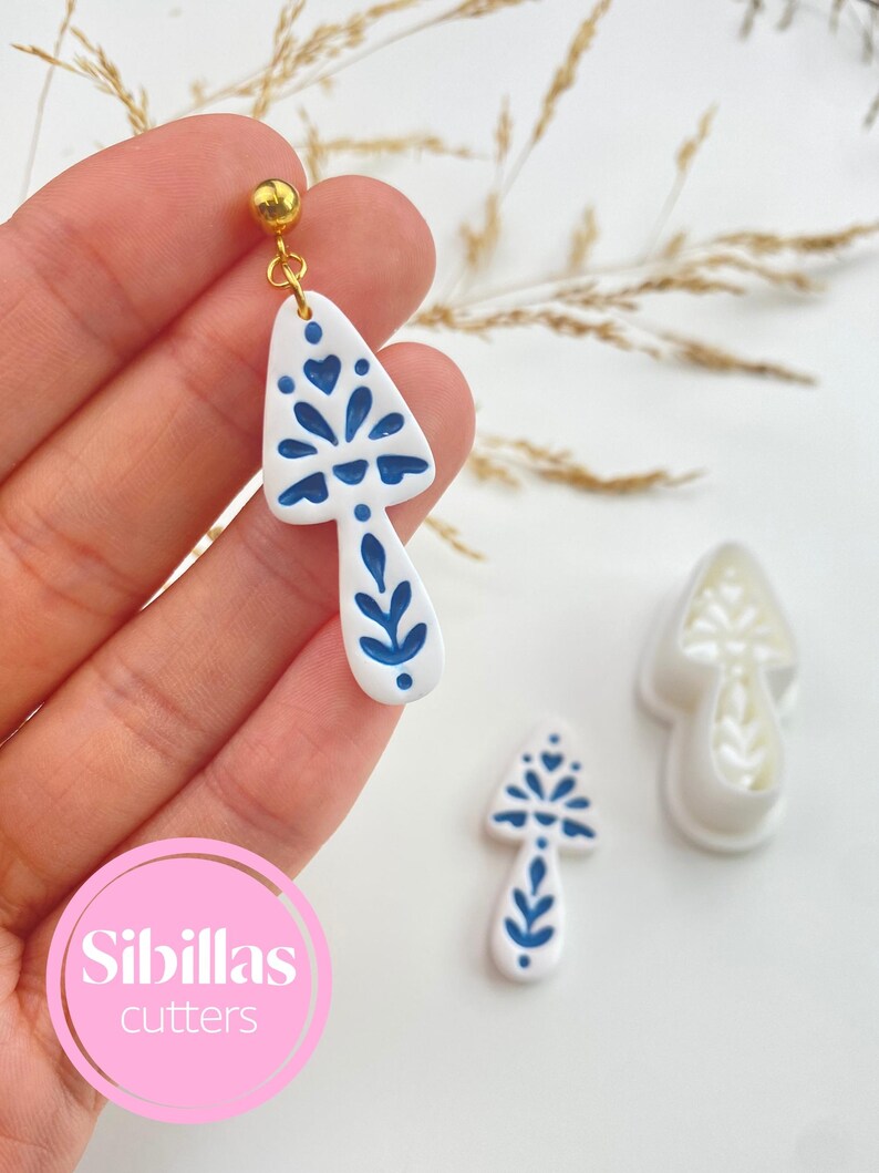 Polymer clay earring cutters with Scandinavian folk art shapes, perfect for fall jewelry, Halloween charms, and clay crafts.