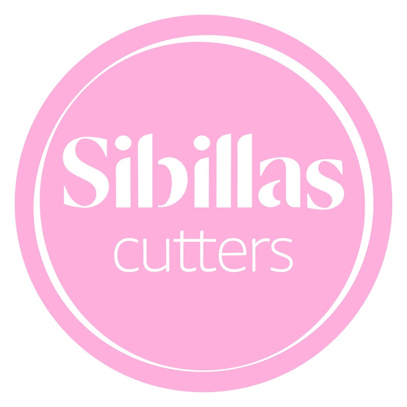 May include: A pink circular logo with a white border. The logo features the name "Sibillas" in large, elegant white letters above the word "cutters" in smaller, white letters. The background is a solid, light pink color.