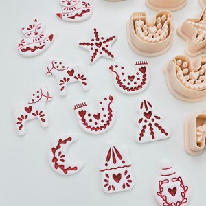 Scandinavian Christmas polymer clay cutter set with festive folk designs.