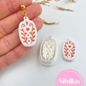 Polymer clay earring supply with Nordic folk art cutters, fall shapes, spooky Halloween designs, and handmade clay tools.