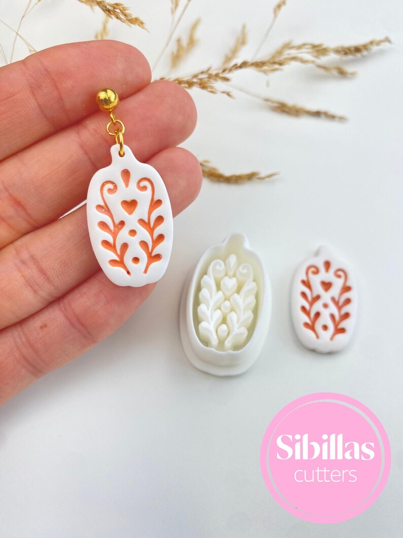 Polymer clay earring supply with Nordic folk art cutters, fall shapes, spooky Halloween designs, and handmade clay tools.