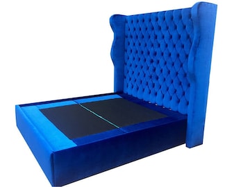 May include: A blue upholstered bed frame with a tall headboard featuring a tufted design. The headboard is tall and has a wingback style.