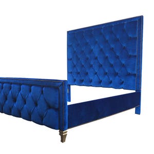 May include: A blue velvet tufted headboard and footboard bed frame with gold accents.
