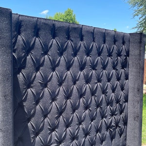 May include: A black tufted headboard with a diamond pattern. The headboard is made of a soft, plush fabric.
